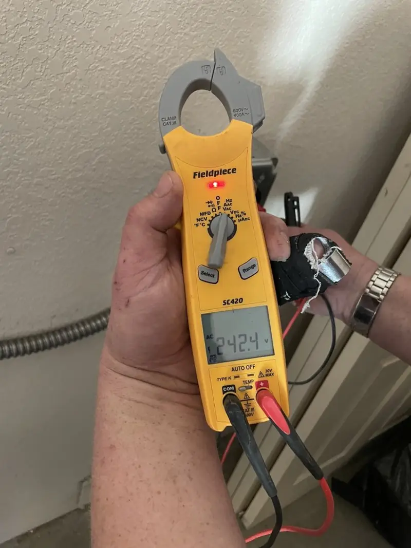 Voltage testing with clamp meter during Recessed Lighting Installation in Broadview